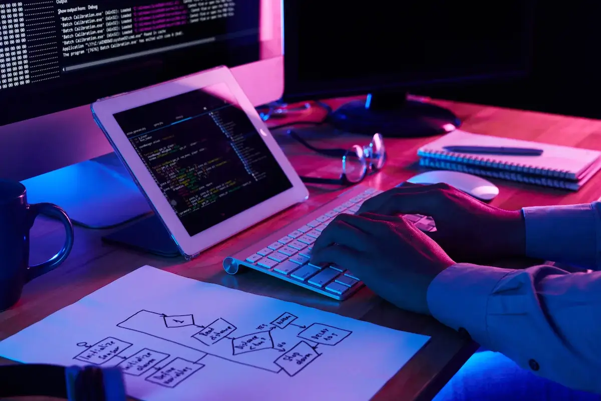 Close-up image of programmer working at his desk in office